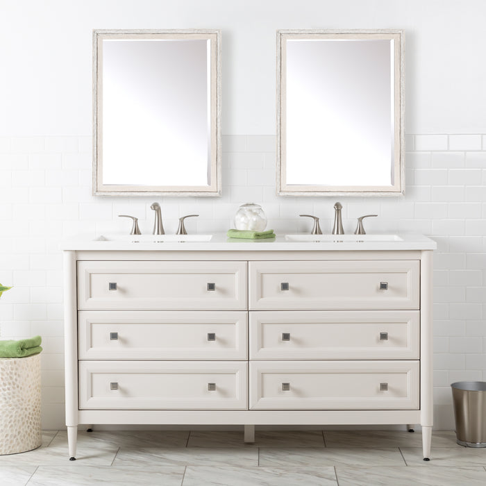 Front view of the Bolivar 61" double-sink dresser-style vanity which features a traditional design with 6 inset, recessed-panel cabinet drawers in a soft off-white finish. Shown here with mirrors, hand towel and other bathroom items.