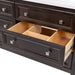 Up close view of an extended drawer of the Bolivar 61" double-sink dresser-style vanity which features a traditional design with 6 inset, recessed-panel cabinet drawers in a rich brown finish