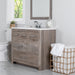 Breena 36.5 in single-sink vanity with woodgrain finish, 3 doors, 1 drawer, interior shelf, polished chrome hardware, and white sink top installed in bathroom with faucet and mirror