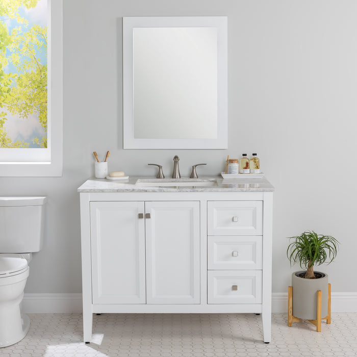 Cartland 43-in white bathroom vanity with 2-door cabinet, 3 drawers, garnite-look sink top installed in bathroom with faucet and mirror