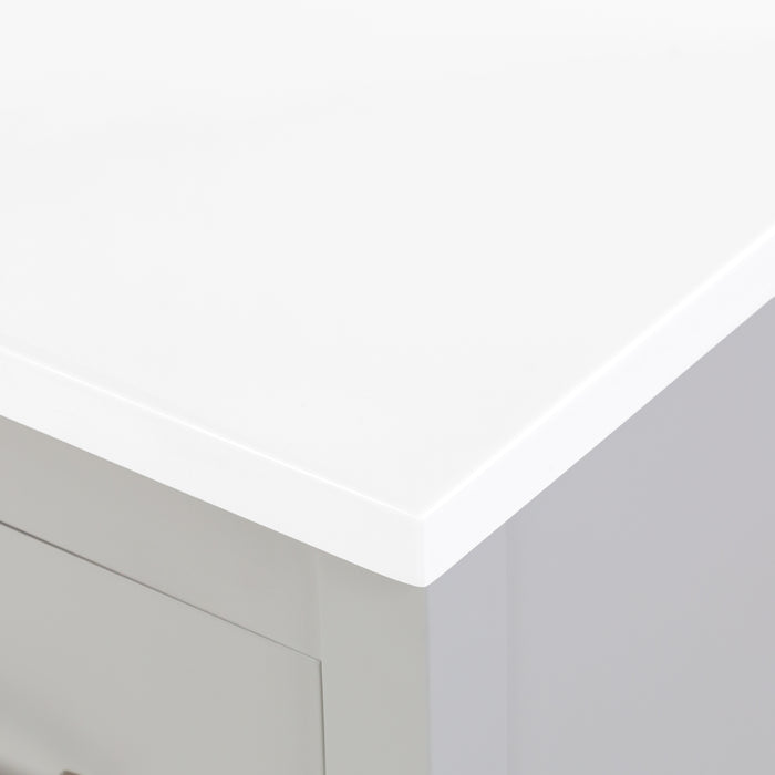 Countertop corner of Tilford gray furniture-style bathroom vanity with 1-door cabinet, 3 drawers, white sink top