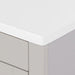 Corner closeup of Lonsdale 36 inch warm gray powder room vanity with 2 doors, 3 drawers, and white top with offset sink