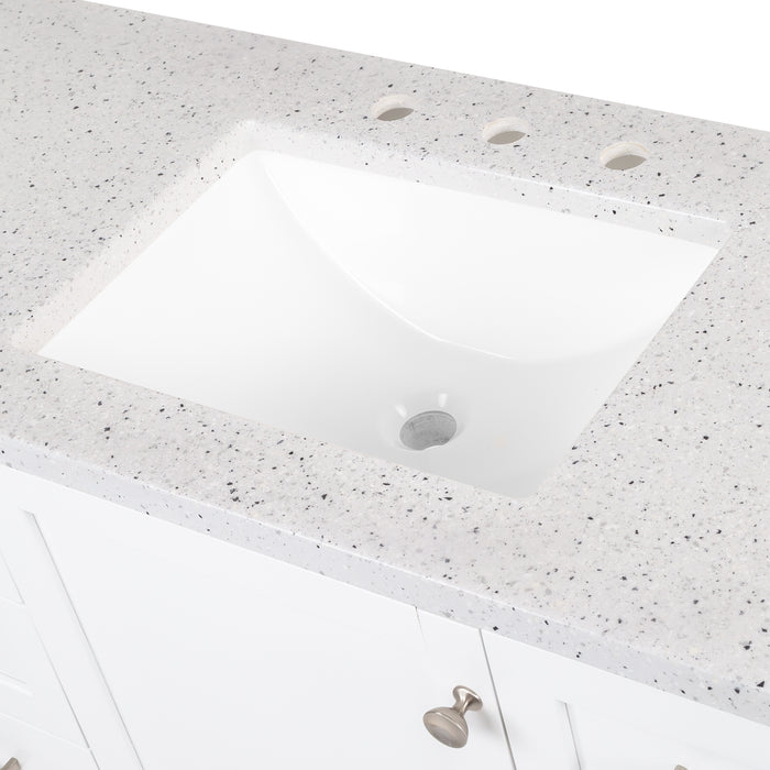 Closeup of predrilled sink on 48 in. Eaton white bathroom vanity with cabinet, 6 drawers, open shelf, adjustable legs, and brushed nickel handles with granite-look sink top