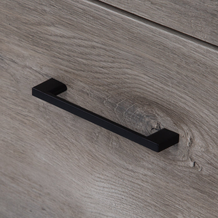 Matte black drawer handle on Nixie, white-washed oak woodgrain finish vanity