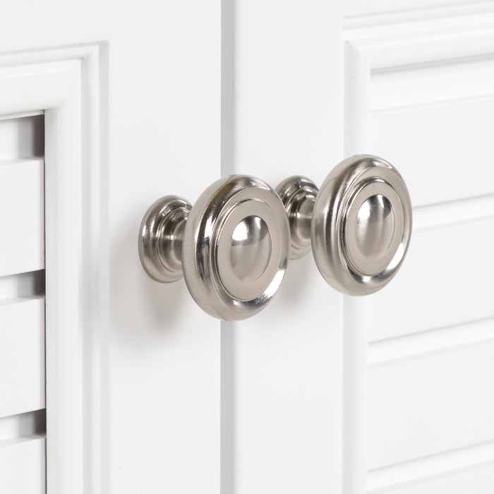 Close view of round, satin nickel door pull hardware on 24.5” wide Rafferty bathroom vanity,