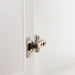 adjustable hinge on white bathroom vanity with louvered doors
