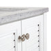 View of White Rafferty bathroom vanity with louvered doors, stone-look top, bottom drawer