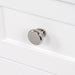 Polished chrome drawer pull on Sykes 31 in white bathroom vanity with 2 drawers, open shelf, cabinet, and white sink top