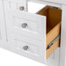 Open top drawer with false front on Sykes 31 in white bathroom vanity with 2 drawers, open shelf, cabinet, and white sink top
